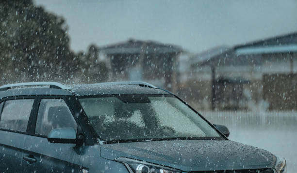 Hail storm over cars in an outdoor car park